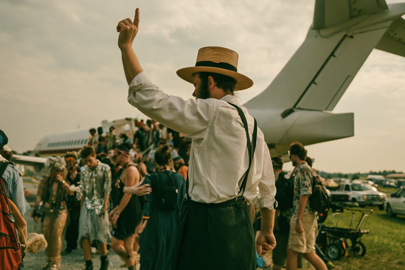 Festivalgoers arriving on the grass airstrip